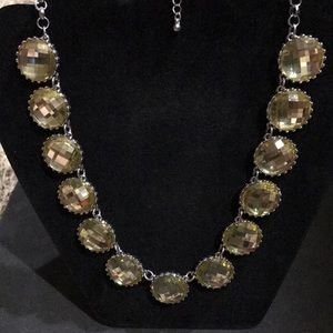 Statement necklace with yellow stones.